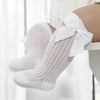 White lace knee socks for a baby girl with a decorative bow