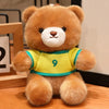 A fluffy brown teddy bear wearing a yellow and green football jersey with the number 9.