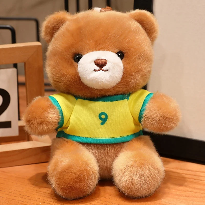 A fluffy brown teddy bear wearing a yellow and green football jersey with the number 9.