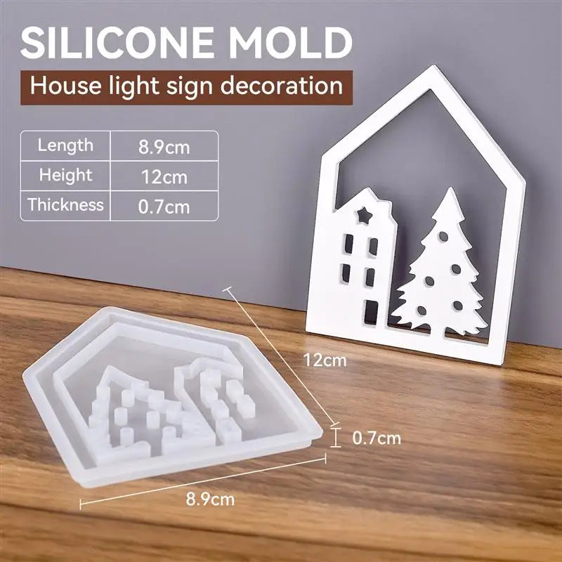 A white silicone mold set for house, love, and Christmas ornaments is displayed on a wooden surface.