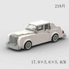 A white classic rally car model built from building blocks, shown in a side view.