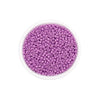 A clear container filled with purple Czech glass seed beads for jewelry making