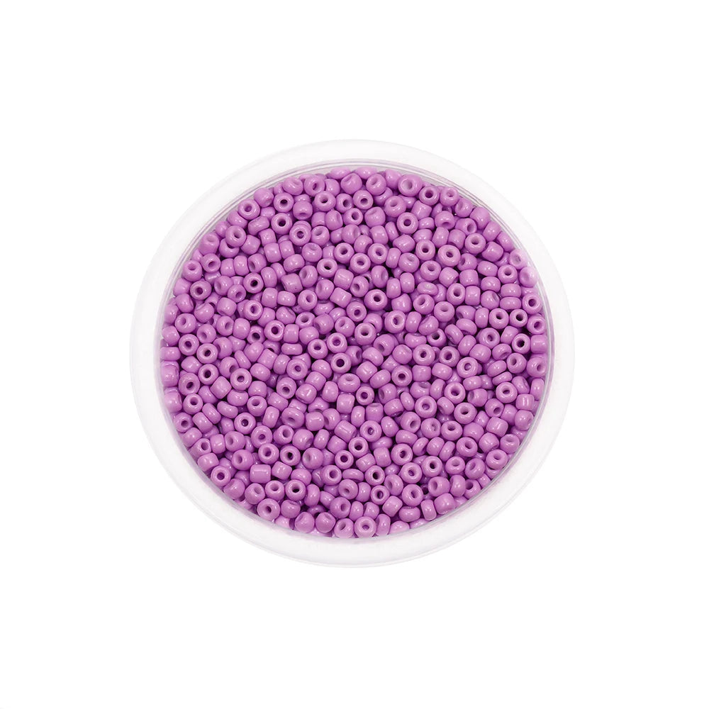A clear container filled with purple Czech glass seed beads for jewelry making