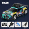 A black and teal remote control car with a large camera mounted on the roof, shown in a studio setting.