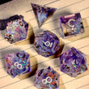 A collection of handcrafted resin polyhedral dice in light purple with gold numbers scattered on lined paper.