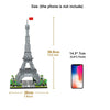 A miniature model of the Eiffel Tower built from gray blocks, shown next to a smartphone for scale.