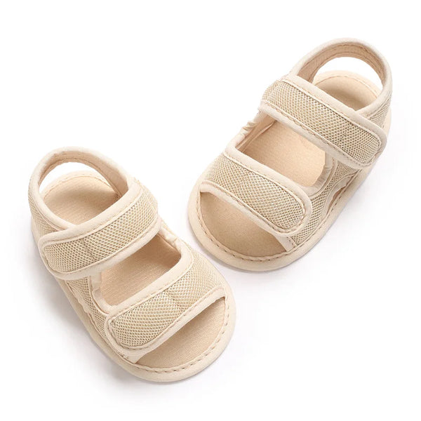 A pair of beige breathable summer baby pre-walker sandals for infants.