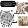 A cat-shaped wooden jigsaw puzzle with 135 unique pieces, shown being affixed to a wall using double-sided tape.