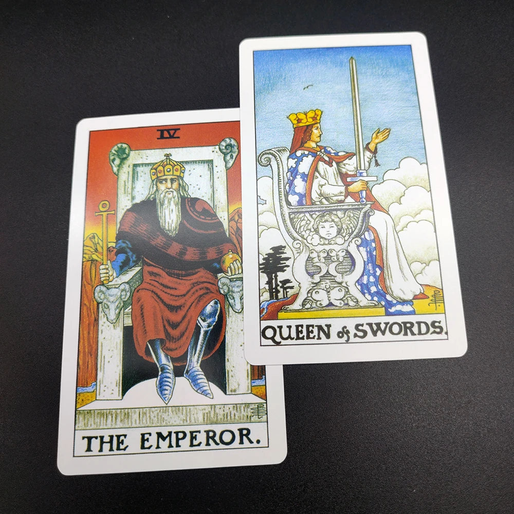 Two tarot cards, The Emperor and Queen of Swords, are displayed against a dark background.