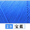 Close-up texture of bright blue premium milk cotton yarn used for knitting or crochet projects.