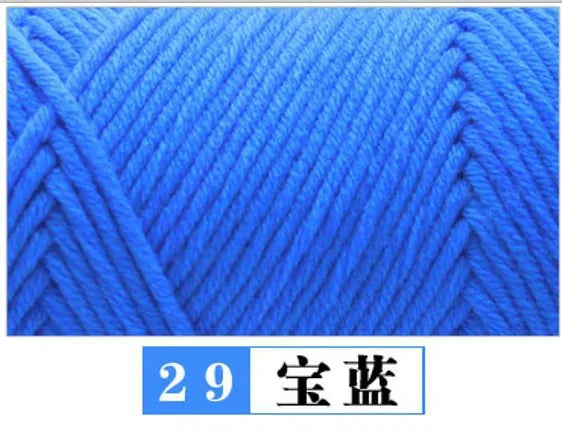 Close-up texture of bright blue premium milk cotton yarn used for knitting or crochet projects.