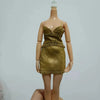 A fashion doll wearing a gold sequined dress and a gold top, displayed against a light background.
