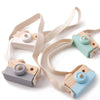 Montessori wooden camera teether toy with light wood and pastel colored plastic body and strap