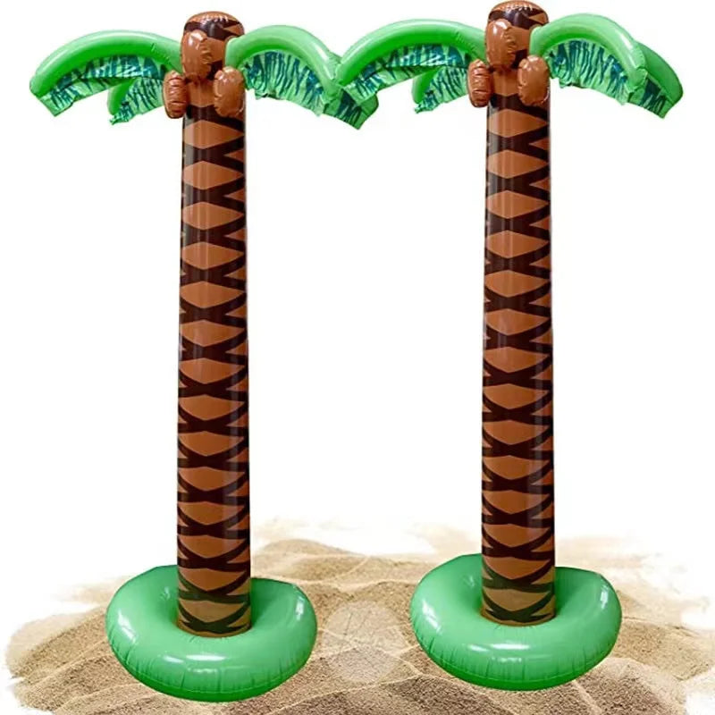 Oversized inflatable palm tree with green fronds and brown trunk set against a sandy background