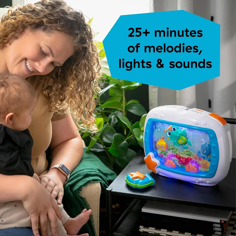 An ocean-themed crib soother with remote, lights, and melodies is shown next to a baby.