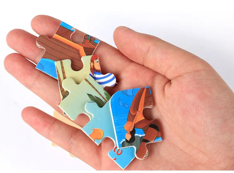 A hand holds together several wooden jigsaw puzzle pieces shaped like animals and vehicles.