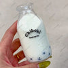 A hand holds a clear bottle of white liquid labeled Chiboki, which is a drink cup toy.