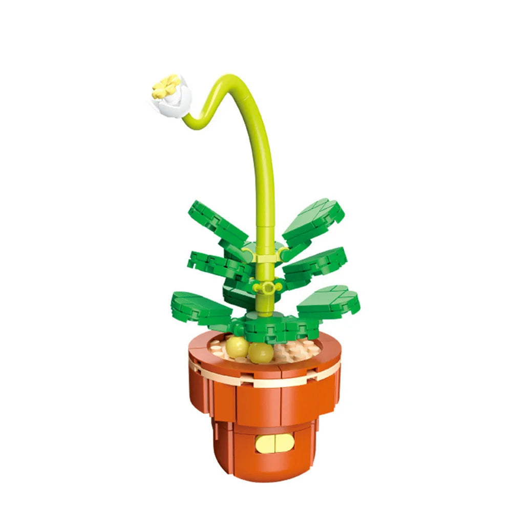 A green and yellow building block set featuring a plant-like structure and an orange base.