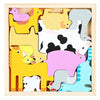 A wooden tangram puzzle board featuring various animal shapes in yellow, pink, and gray.
