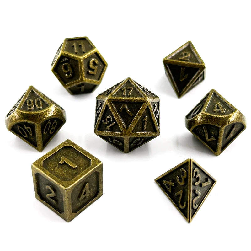 A set of premium metal polyhedral dice with a multicolor gold finish scattered on a white background.