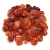 A pile of colorful, translucent amber and reddish-brown acrylic beads for jewelry making.