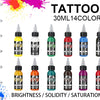 A collection of 14 colors of tattoo ink bottles displayed with black caps and dropper tips.