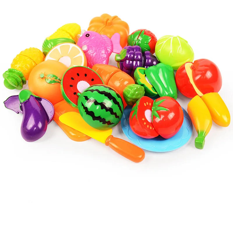 A colorful pretend play kitchen set featuring various plastic fruits and vegetables like apples, tomatoes, and peppers.