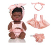 A set of three pink outfits for a baby doll including a bow headband, a top, and a bottom.