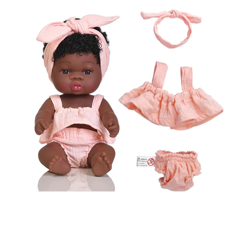 A set of three pink outfits for a baby doll including a bow headband, a top, and a bottom.