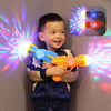A young boy holds an orange projection toy gun with lights and music, illuminating a wall with colorful light beams.