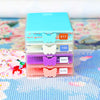 A stack of clear plastic diamond painting storage trays with butterfly shaped inserts and lids in various pastel colors.