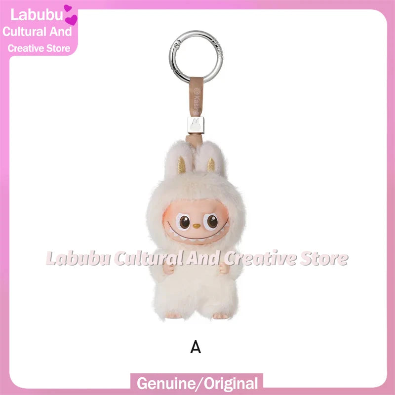 A small, fluffy white Labubu plush doll with long ears attached to a silver keychain ring.