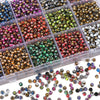 A collection of various colored glass beads in small plastic containers and loose, including gold, green, red, and purple sha