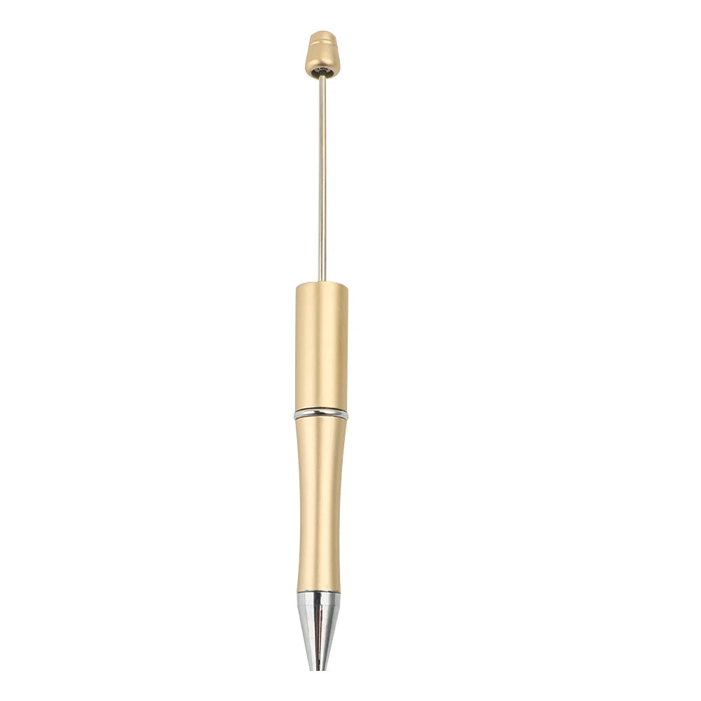 A gold-colored ballpoint pen with a metallic finish and a silver tip.