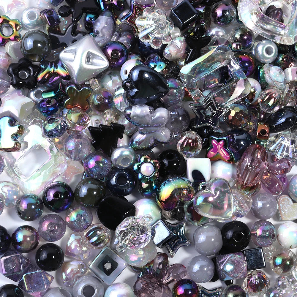 A close-up view of a variety of colorful acrylic bow beads and small glass beads in various shades and shapes.