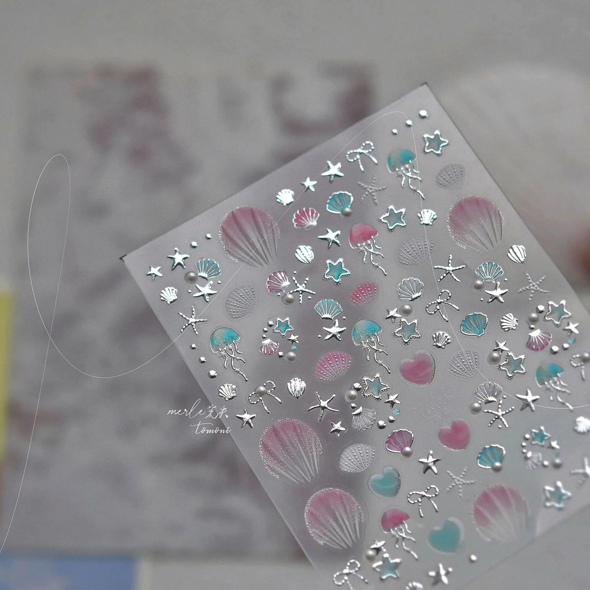Clear nail art stickers featuring 3D ocean themes like gold shells, starfish, and various colored accents.