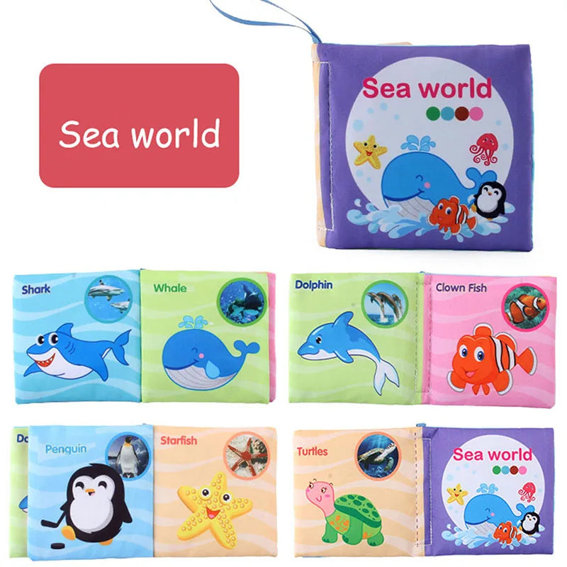 A set of soft fabric baby books featuring sea animals like sharks, whales, dolphins, fish, penguins, and turtles.