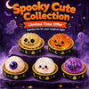 A collection of spooky cute items including a Jack-o'-lantern, ghost figures, and squishy toys displayed on a purple surface.