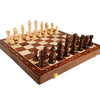 A handcrafted wooden folding chess set with solid walnut pieces on a chessboard.