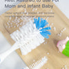 A white nylon bristled brush and a blue silicone brush are shown on a wooden board with small white balls, used for cleaning 