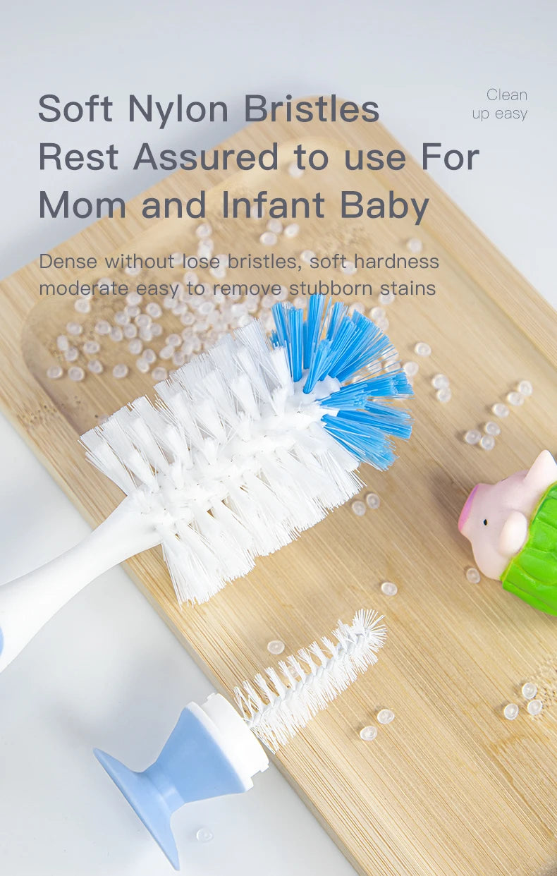 A white nylon bristled brush and a blue silicone brush are shown on a wooden board with small white balls, used for cleaning 