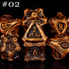 A set of seven polyhedral metal dice in a bronze or gold finish, arranged against a black background.
