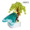 A set of 186 pieces of rose flower building blocks shaped like a tree with green foliage and a large blue leaf.