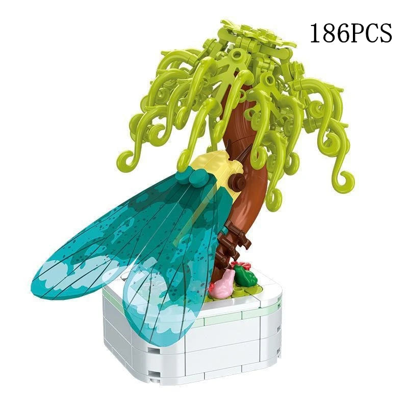 A set of 186 pieces of rose flower building blocks shaped like a tree with green foliage and a large blue leaf.