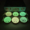 A collection of soft sensory squishy dumpling toys in various shades of green and light pastel colors.