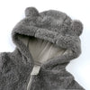 A close-up of a gray baby bear fleece hooded romper with a zipper.