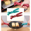 Three silicone pot grippers and metal tongs in red, green, and pink are shown gripping food items.