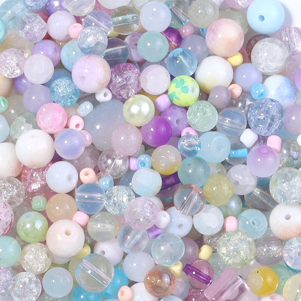 A close-up view of a vibrant mix of iridescent glass beads in various pastel colors like pink, purple, blue, and green.