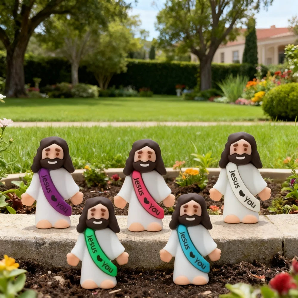 A set of five small white religious statues depicting Jesus with a pink sash and the words Jesus you