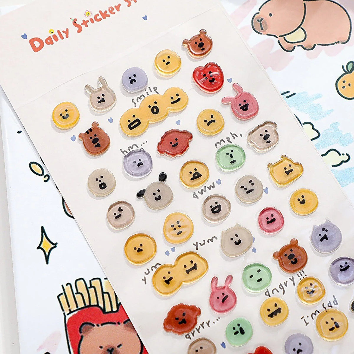 A sheet of daily sticker craft supplies featuring various 3D smile face crystal stickers in pastel colors.